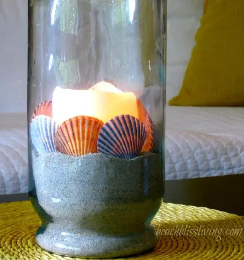 Candle in Glass Vase and Glowing Shells
