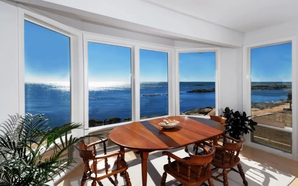 http://www.blucarrot.com/wp-content/uploads/2015/06/Beach-Apartment-Interior-Design-Come-With-Varnished-Wooden-Dining-Chair-And-Round-Wooden-Dining-Table-With-Beach-View-Bay-Window.jpg
