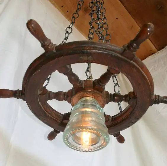 lamp hanging from ship wheel